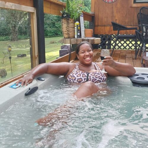 Nicole relaxing with a glass of wine in the hot-tub. 